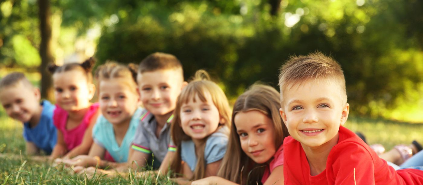 Happy children lying in the grass